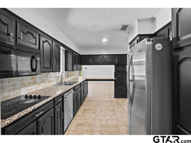 kitchen with a sink, visible vents, ornamental molding, backsplash, and black appliances