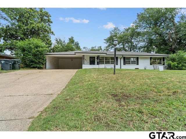 1812 Montrose Dr, Tyler, TX 75701 - view of front of property with concrete driveway, a front yard, and an attached carport