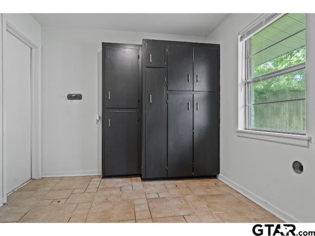 1812 Montrose Dr, Tyler, TX 75701 - unfurnished bedroom with baseboards, a closet, and stone finish floors