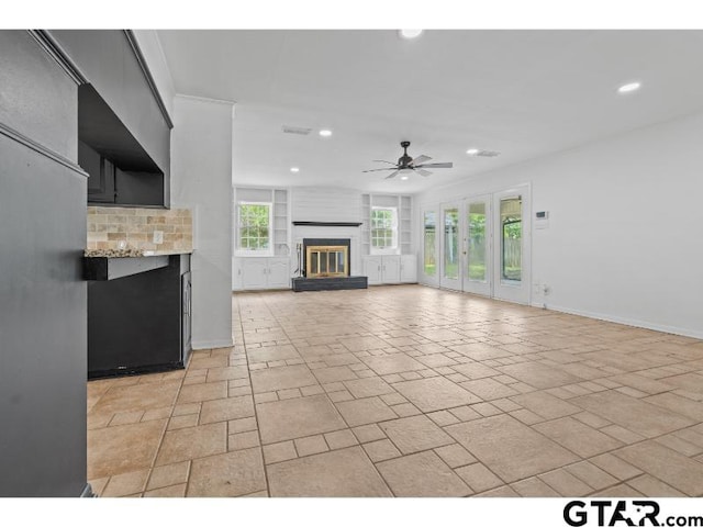 1812 Montrose Dr, Tyler, TX 75701 - unfurnished living room with a glass covered fireplace, ceiling fan, recessed lighting, and baseboards