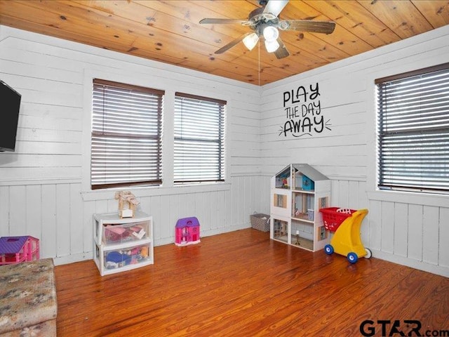 game room with ceiling fan, wood-type flooring, and wooden ceiling