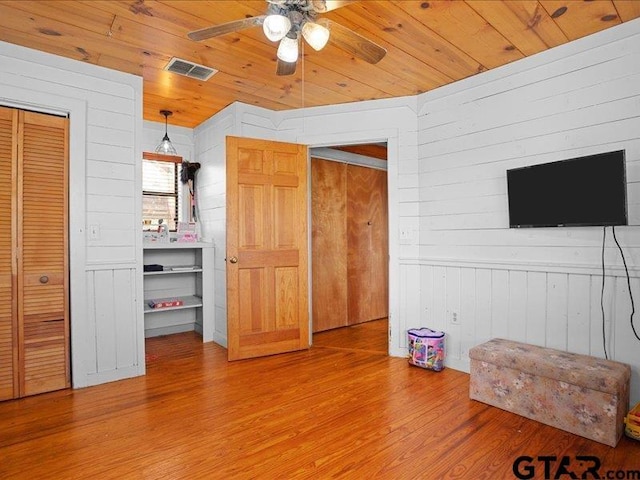 unfurnished living room featuring wood ceiling, ceiling fan, and hardwood / wood-style flooring