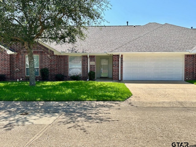 ranch-style home with a front lawn and a garage