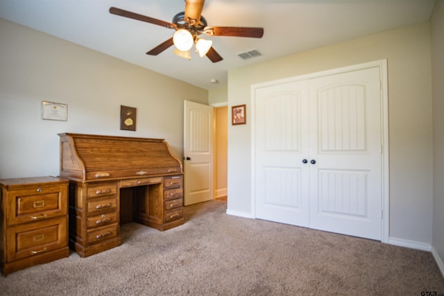 home office featuring ceiling fan and light colored carpet