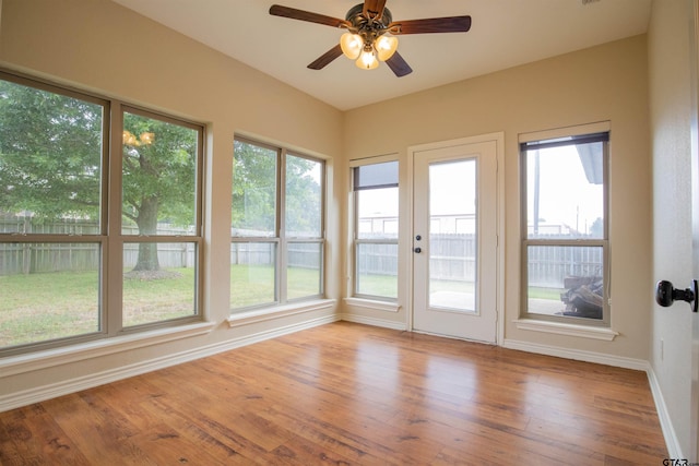 unfurnished sunroom with plenty of natural light and ceiling fan