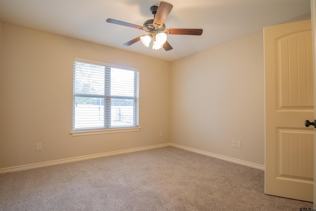 carpeted empty room featuring ceiling fan