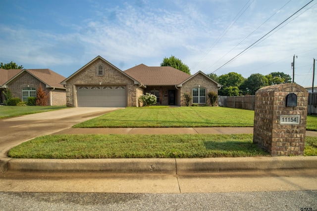 view of front of home with a front lawn and a garage