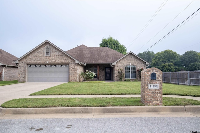 view of front of house with a garage and a front yard