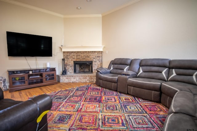 living room with a fireplace, wood-type flooring, and crown molding