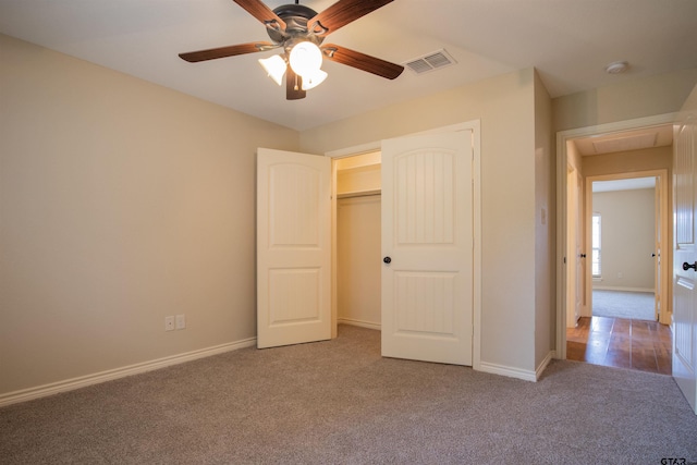 unfurnished bedroom featuring ceiling fan, a closet, and carpet