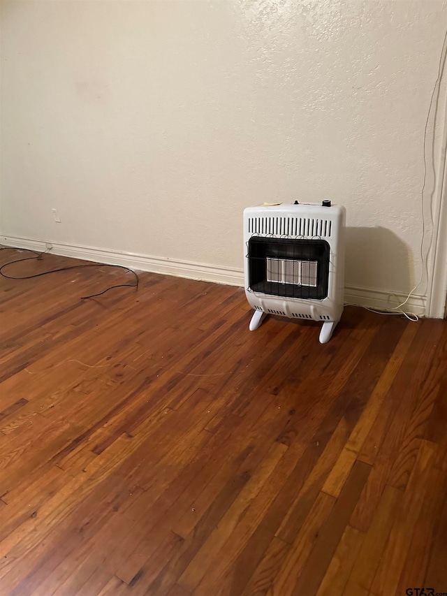 room details featuring hardwood / wood-style flooring and heating unit