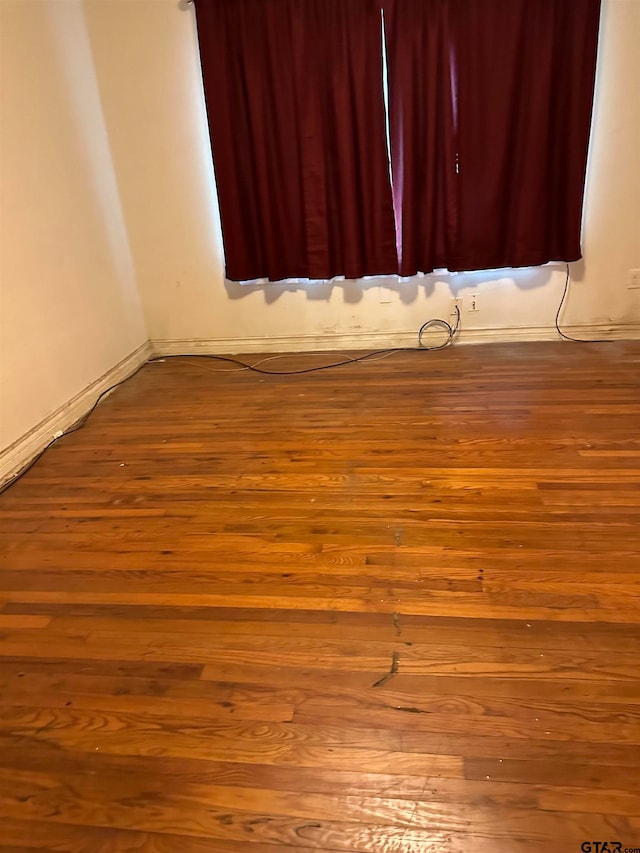 empty room with wood-type flooring