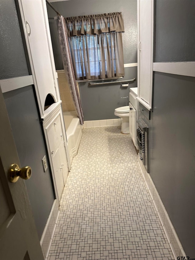 bathroom with toilet and shower / bath combo with shower curtain