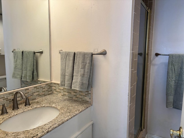 20868 Bay Shore Dr, Flint, TX 75762 - bathroom featuring vanity, backsplash, and a stall shower