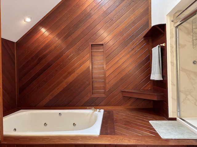 20868 Bay Shore Dr, Flint, TX 75762 - bathroom featuring a shower stall, a tub with jets, and wooden walls