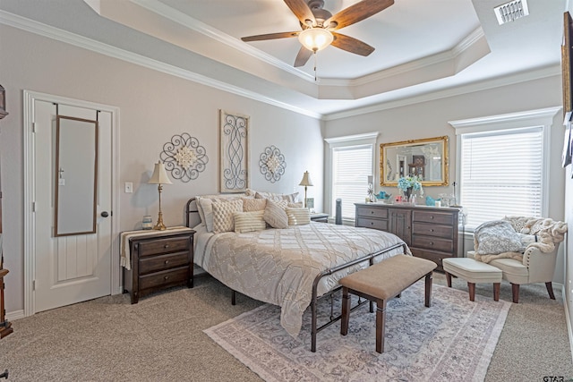 bedroom featuring light carpet, crown molding, a raised ceiling, and ceiling fan