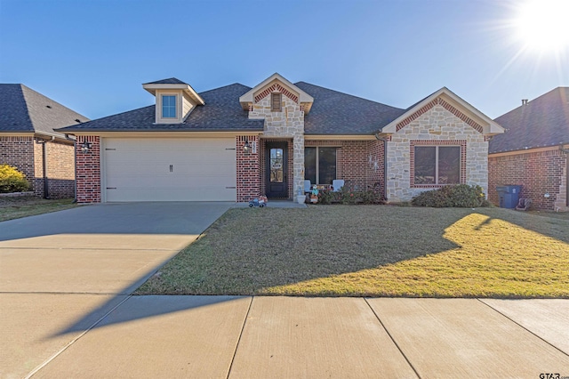 view of front of property with a garage and a front lawn