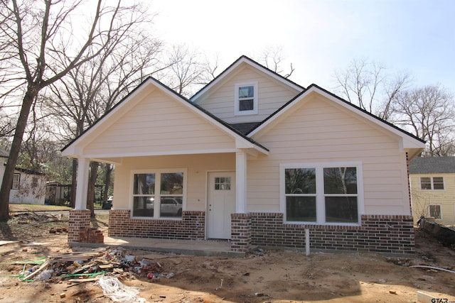 bungalow with brick siding and covered porch