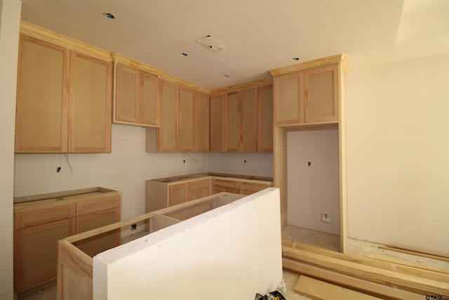 kitchen featuring light brown cabinetry and a center island