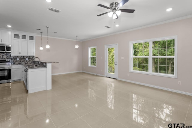 kitchen featuring visible vents, ornamental molding, tasteful backsplash, appliances with stainless steel finishes, and a peninsula