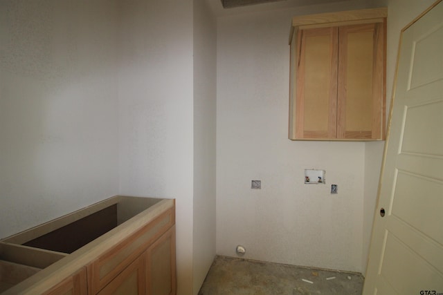 clothes washing area with washer hookup and cabinet space