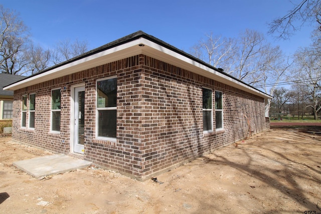 view of side of property with brick siding