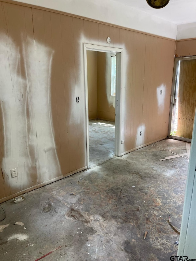 empty room featuring wooden walls