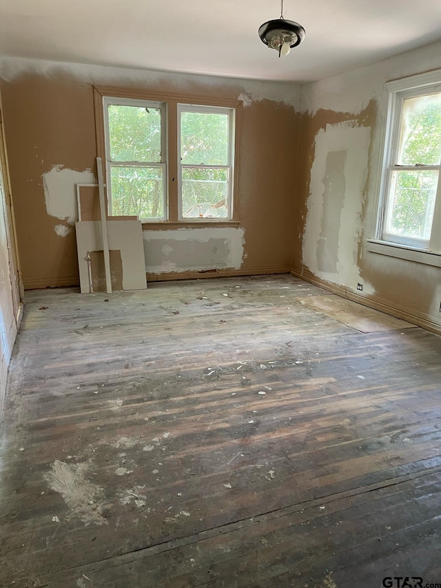 unfurnished room with wood finished floors