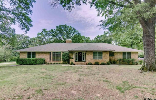 114 Mockingbird, Mount Pleasant, TX 75455 - single story home featuring a chimney and a front lawn