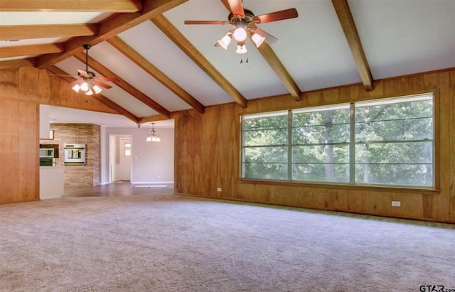 114 Mockingbird, Mount Pleasant, TX 75455 - unfurnished living room with a ceiling fan, wooden walls, beamed ceiling, high vaulted ceiling, and carpet floors