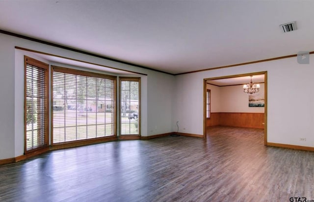 114 Mockingbird, Mount Pleasant, TX 75455 - spare room featuring a chandelier, wood finished floors, baseboards, ornamental molding, and wainscoting