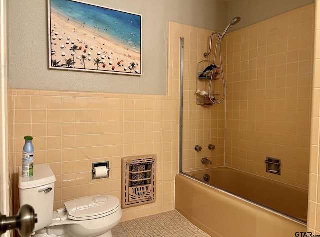 114 Mockingbird, Mount Pleasant, TX 75455 - bathroom with toilet, heating unit, tub / shower combination, and tile walls