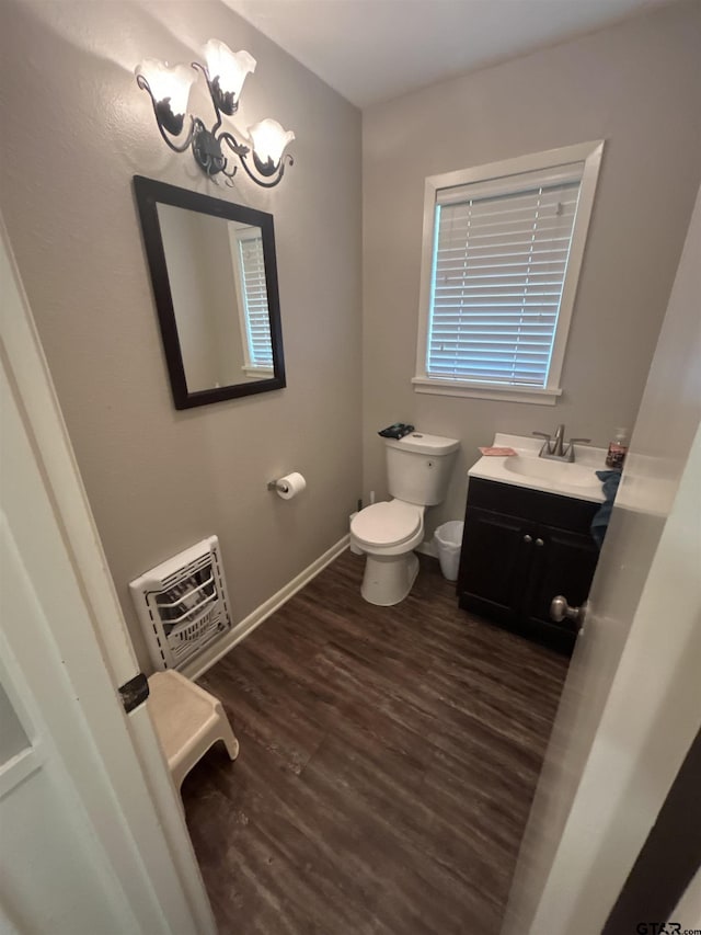 114 Mockingbird, Mount Pleasant, TX 75455 - half bathroom featuring toilet, vanity, wood finished floors, heating unit, and baseboards