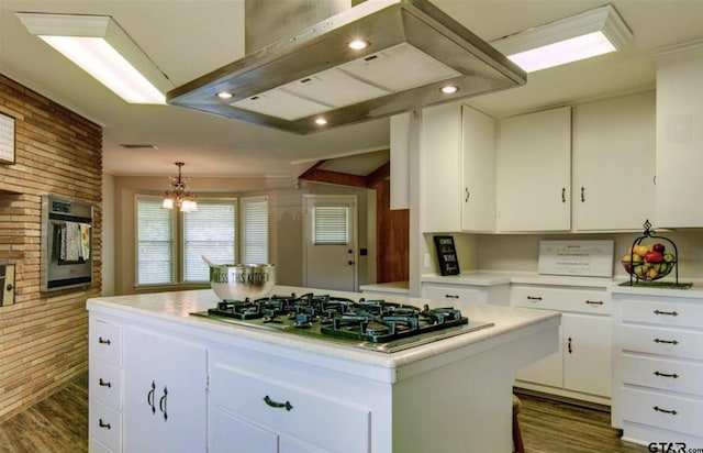 114 Mockingbird, Mount Pleasant, TX 75455 - kitchen featuring appliances with stainless steel finishes, extractor fan, dark wood finished floors, light countertops, and brick wall