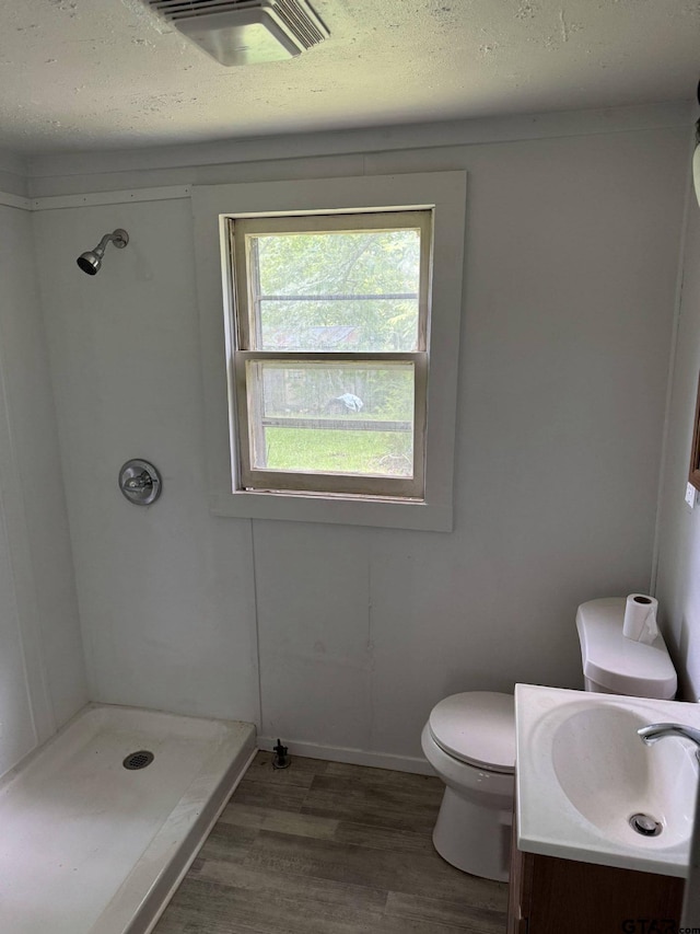 4066 County Rd 398, Tyler, TX 75707 - full bath featuring a shower stall, vanity, wood finished floors, and a textured ceiling