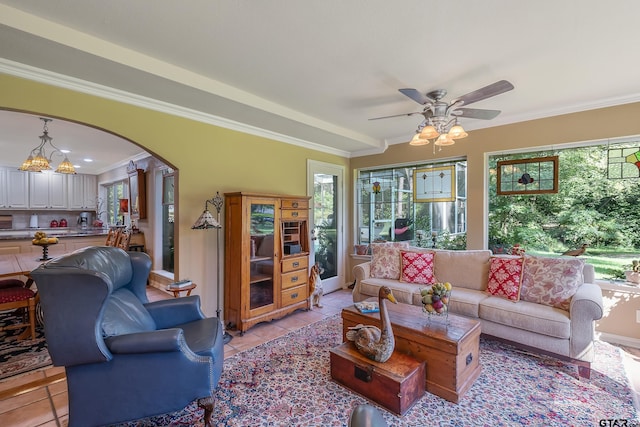 living room featuring ornamental molding, ceiling fan, and light tile patterned floors