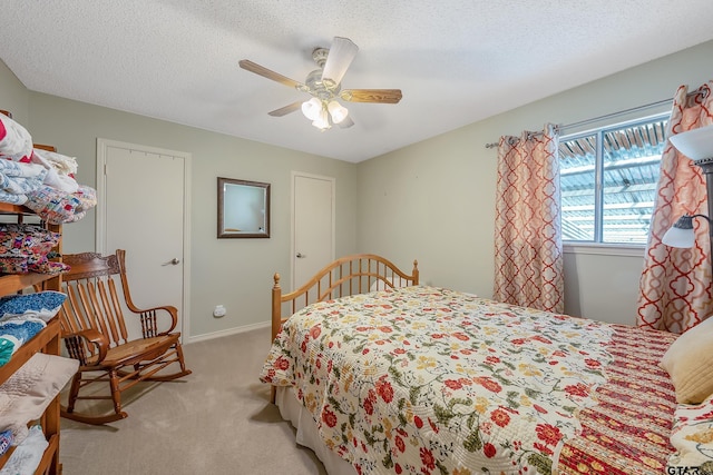 carpeted bedroom with a textured ceiling and ceiling fan