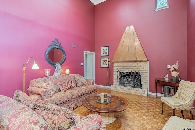 living room with a brick fireplace and parquet flooring