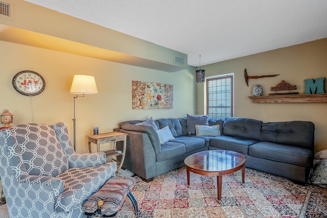 carpeted living room featuring a textured ceiling