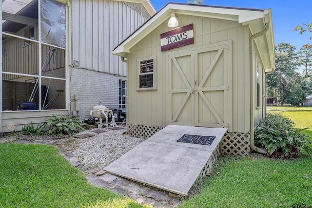 view of outbuilding featuring a lawn