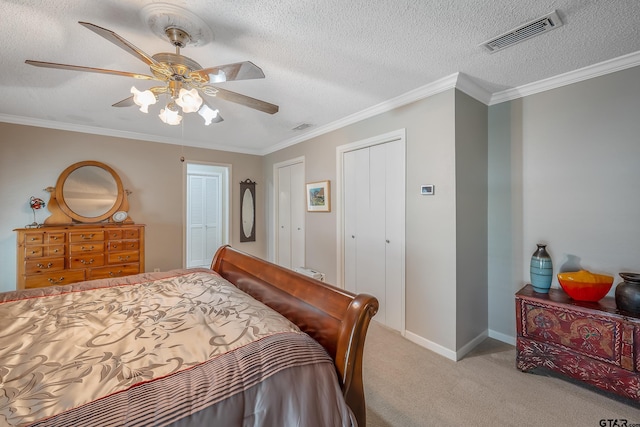 carpeted bedroom with ceiling fan, a textured ceiling, and crown molding