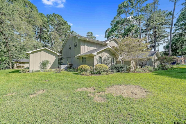 view of front of house featuring a front lawn and a shed