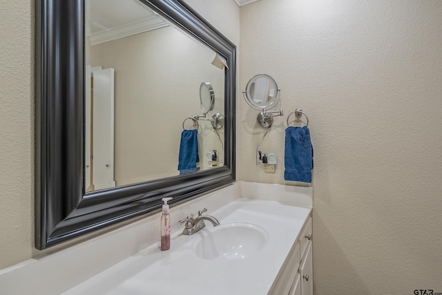 bathroom with vanity and crown molding