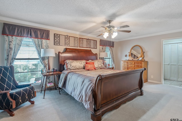 carpeted bedroom with ceiling fan, a textured ceiling, a closet, and ornamental molding