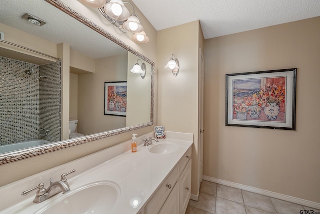 full bathroom with vanity, tile patterned flooring, toilet, and a textured ceiling