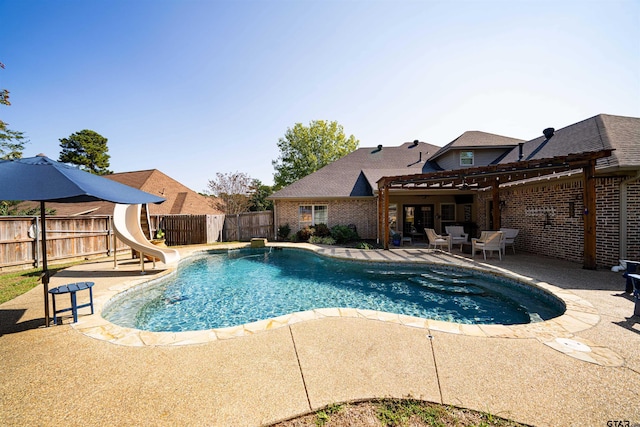 view of swimming pool with a patio and a water slide