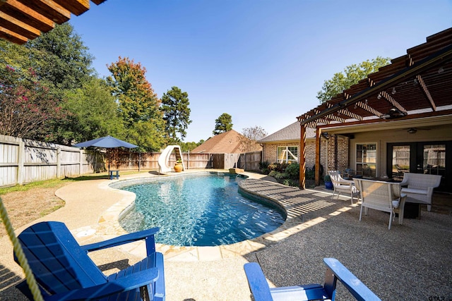 view of pool featuring a pergola, ceiling fan, a water slide, and a patio