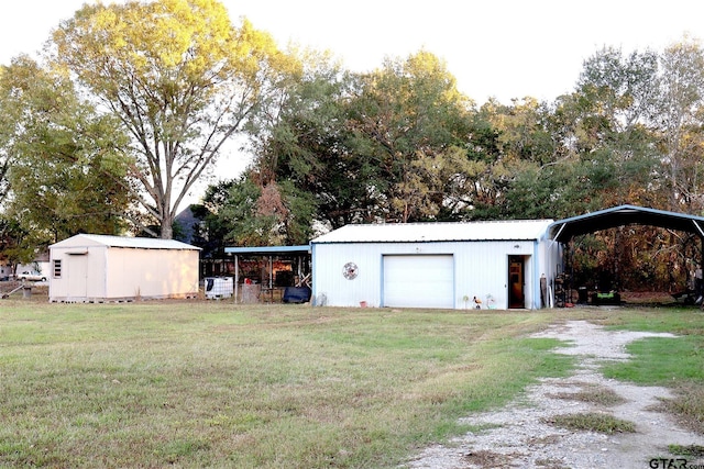 exterior space with a carport, a garage, and an outbuilding