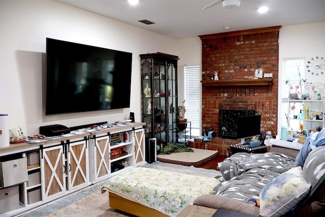 living room with a brick fireplace