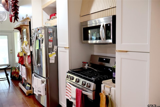 kitchen with dark hardwood / wood-style flooring, white cabinetry, and appliances with stainless steel finishes